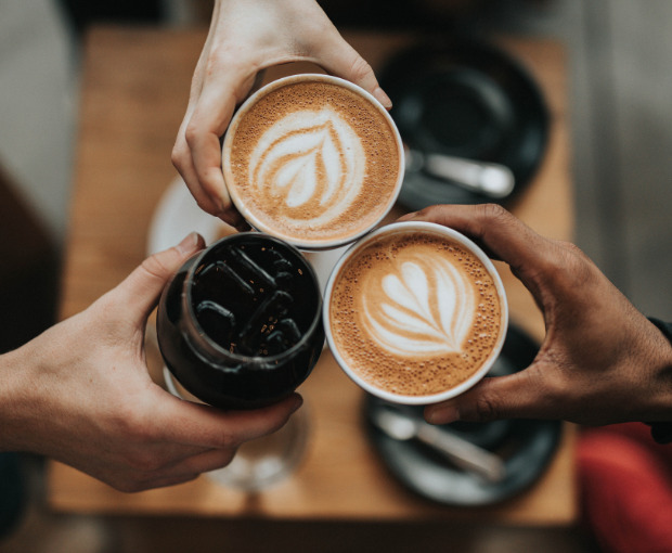 three cups of coffee cheersing