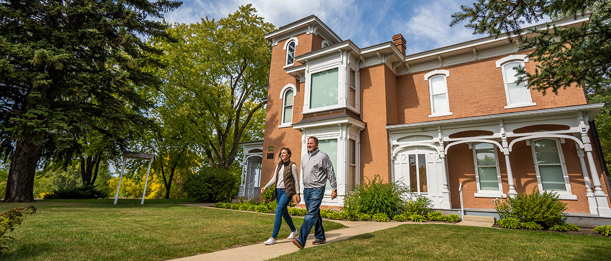 couple walking out of the Mellett house
