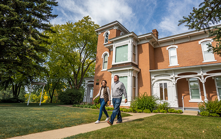 couple walking out of the mellett house
